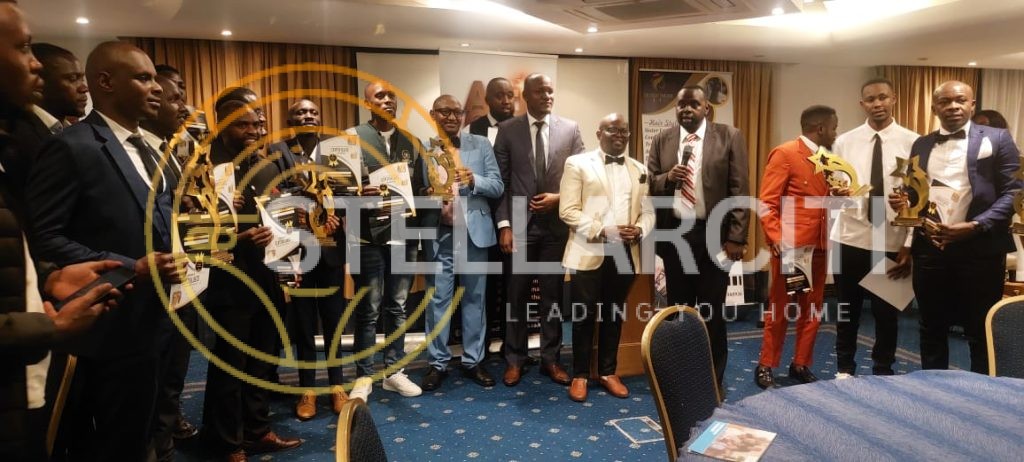 Alexander Ndungu receiving Realtor of the Year award surrounded by the StellarCiti team, celebrating client success