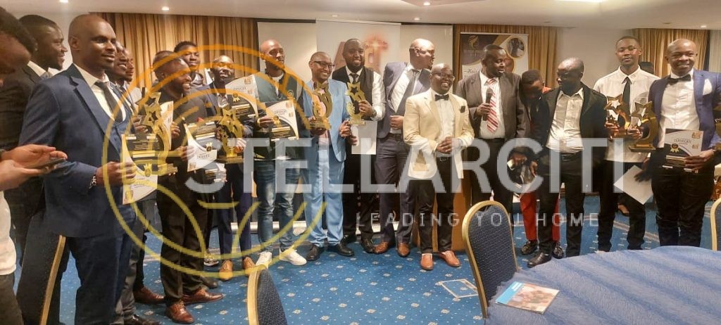 Alexander Ndungu receiving Realtor of the Year award surrounded by the StellarCiti team, celebrating client success