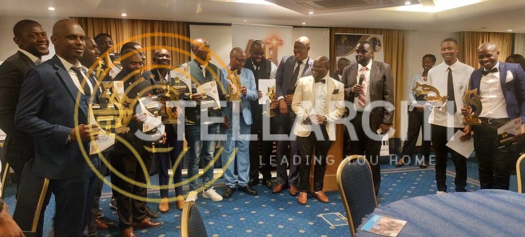 Alexander Ndungu receiving Realtor of the Year award surrounded by the StellarCiti team, celebrating client success